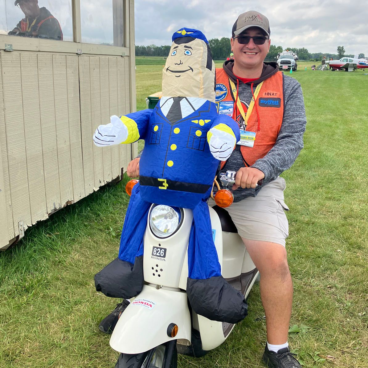 volunteer on moped with inflatable pilot 
