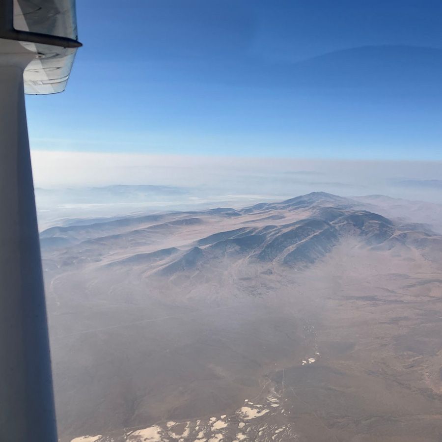 flying over nevada with wildfire haze